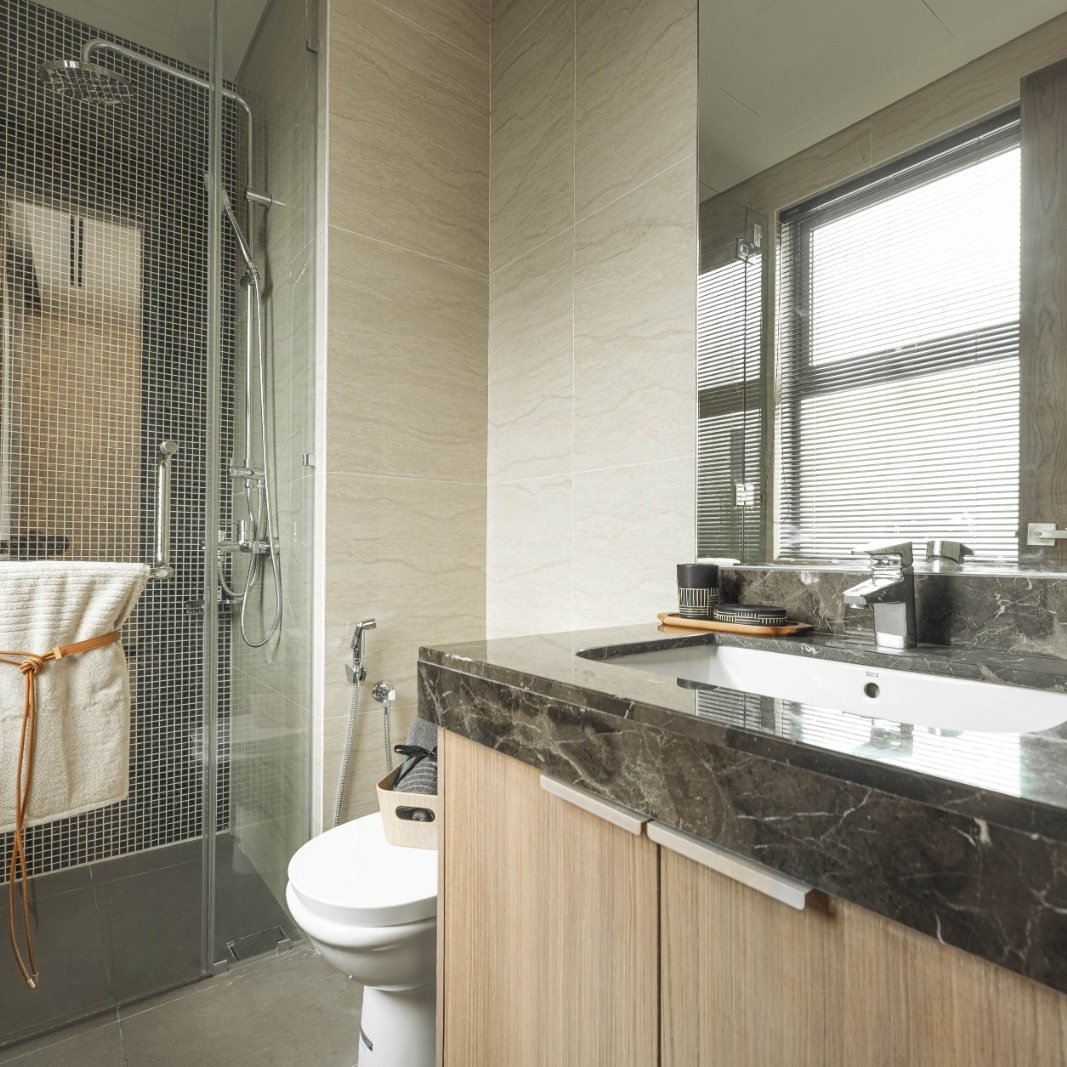 Show unit bathroom with a glass shower and stone vanity