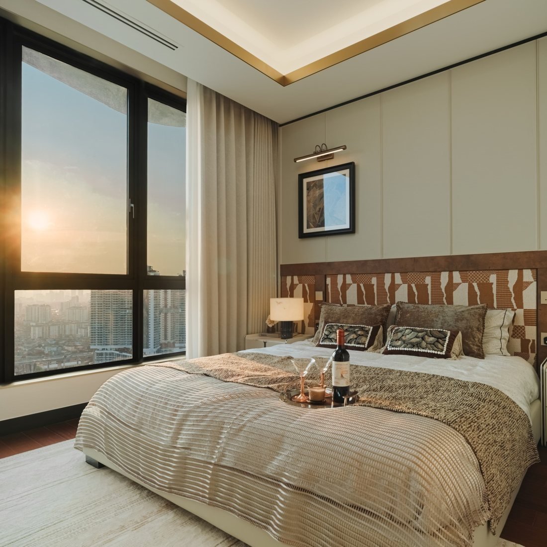 Show unit bedroom with city views at sunset