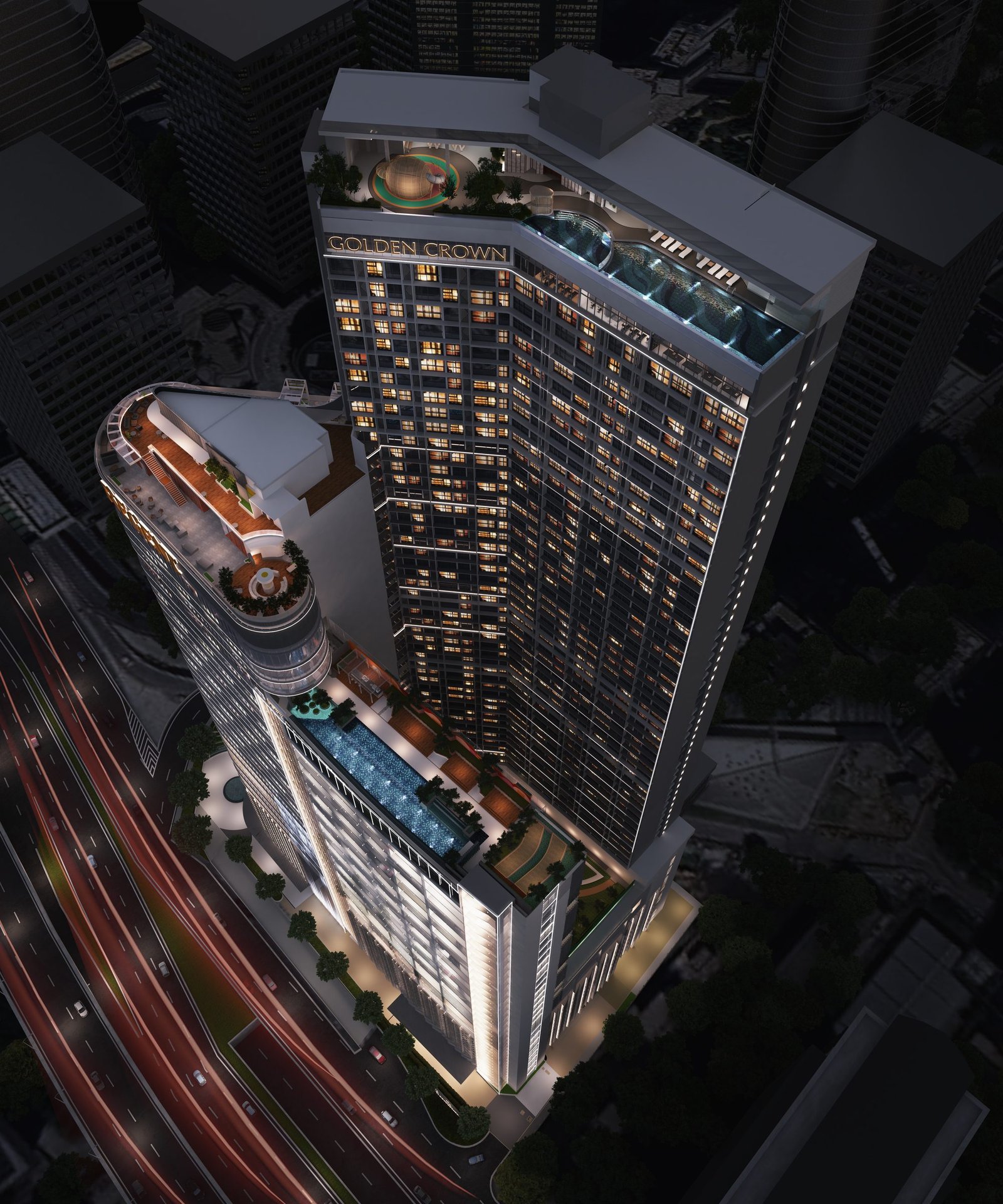 Golden Crown Residence illuminated at night beside the Kuala Lumpur skyline