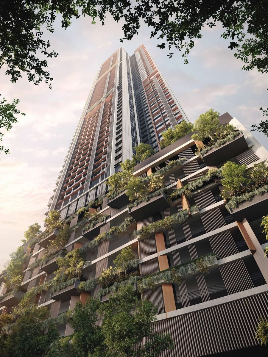 The Parkside Residences tower seen from street level through the trees, in evening light