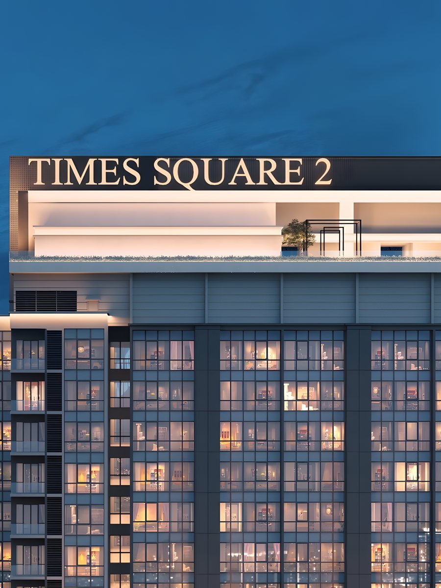 The Times Square 2 name sign on the crown of the tower at dusk